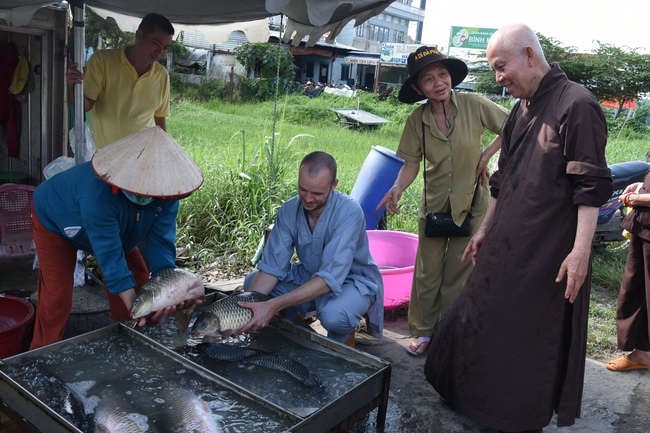 Praying for rebirth and releasing creatures in Ba Lua port, Cu Chi